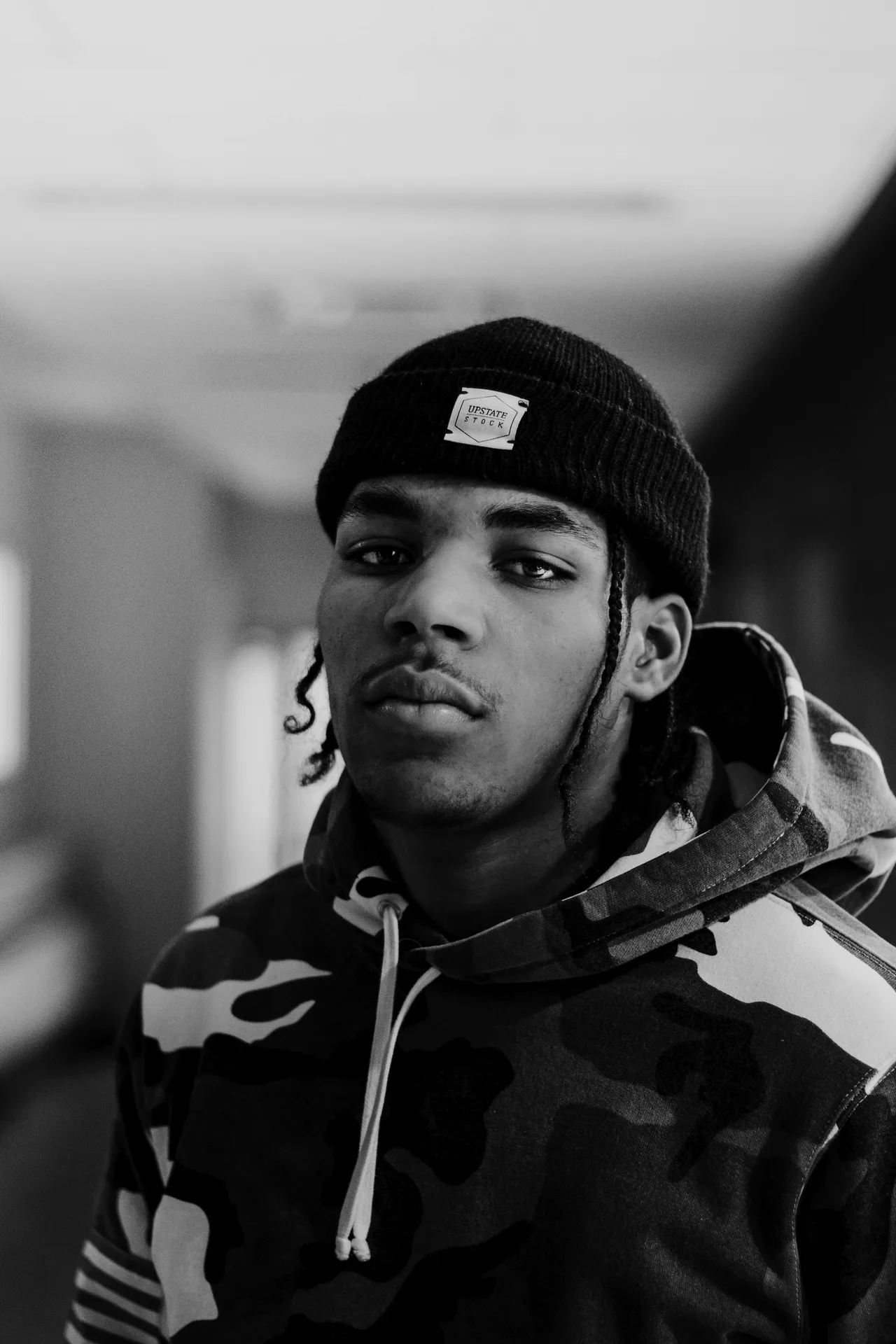 Portrait of Andre Cole in a camo hoodie and beanie